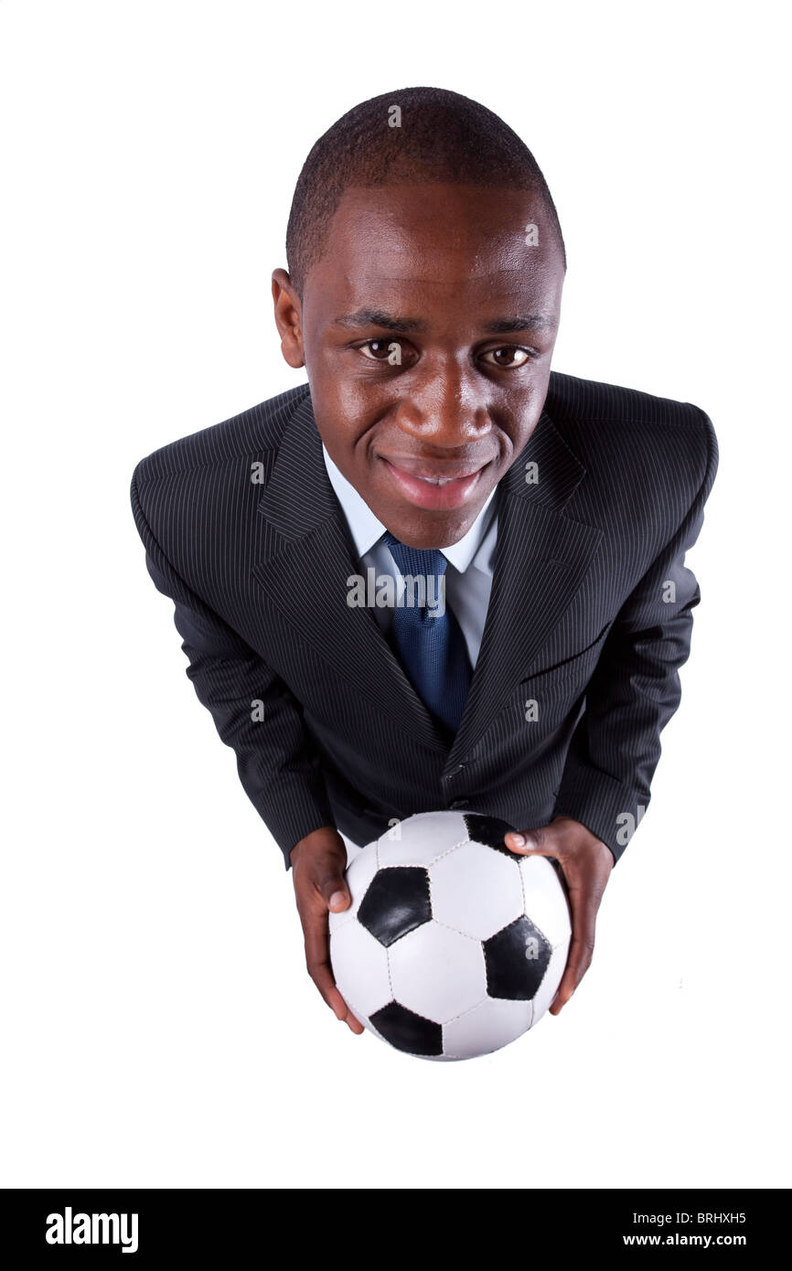 African businessman holding a soccer ball (isolated on white) Stock Photo