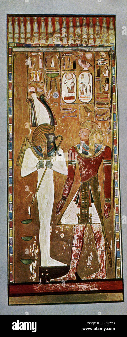 The 19th Dynasty Pharaoh Seti I (left) stands before Osiris, the god of the dead and the underworld. Seti succeeded Ramses I. Stock Photo