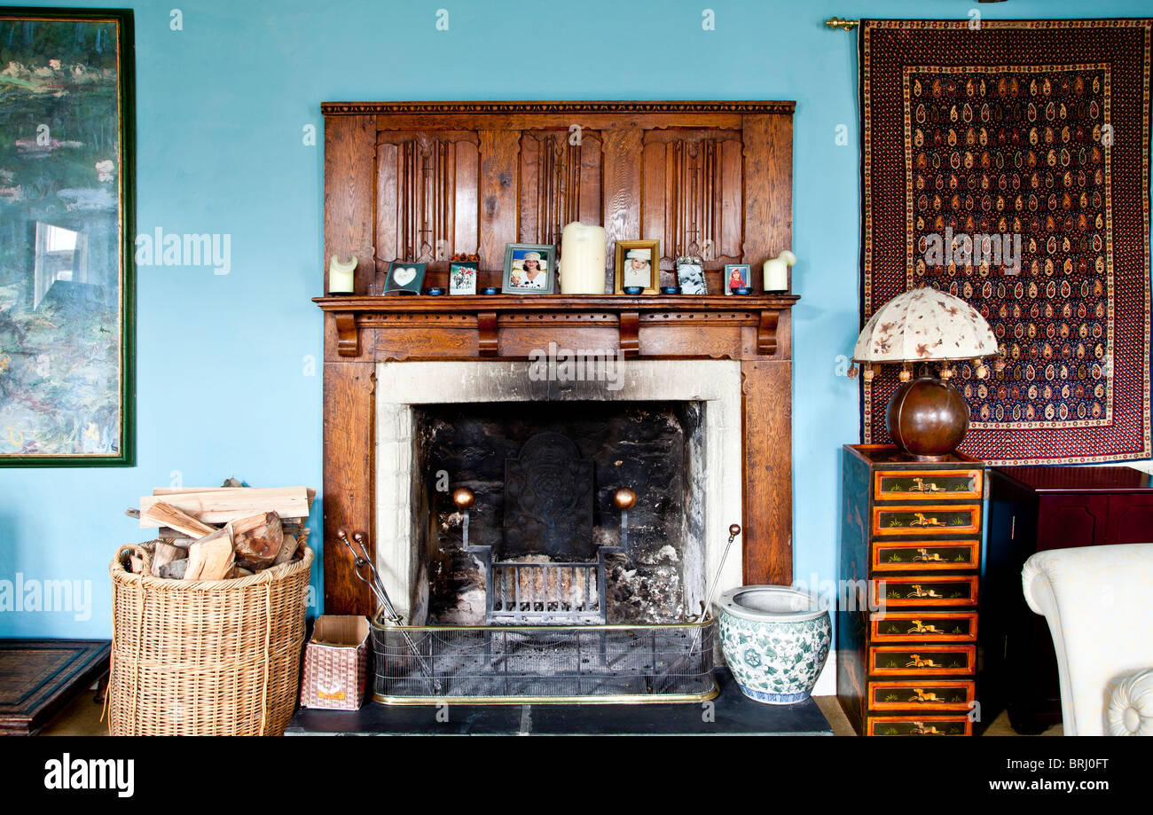 Old fireplace in the drawing room of an old country village house in Wiltshire, England, UK Stock Photo
