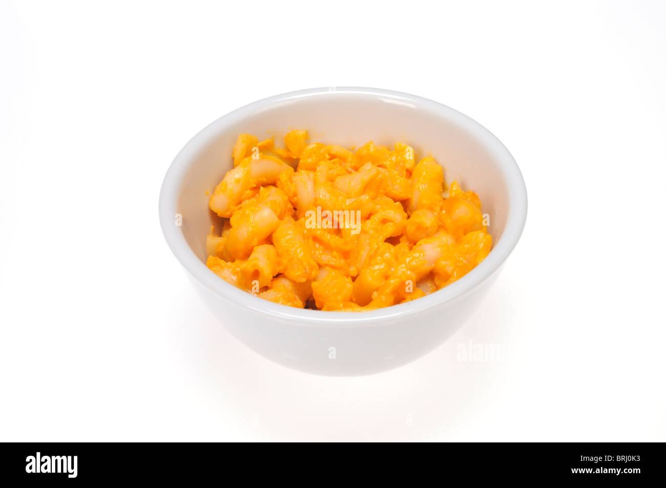 Cooked frozen macaroni and cheese in white bowl on white background cutout. Stock Photo