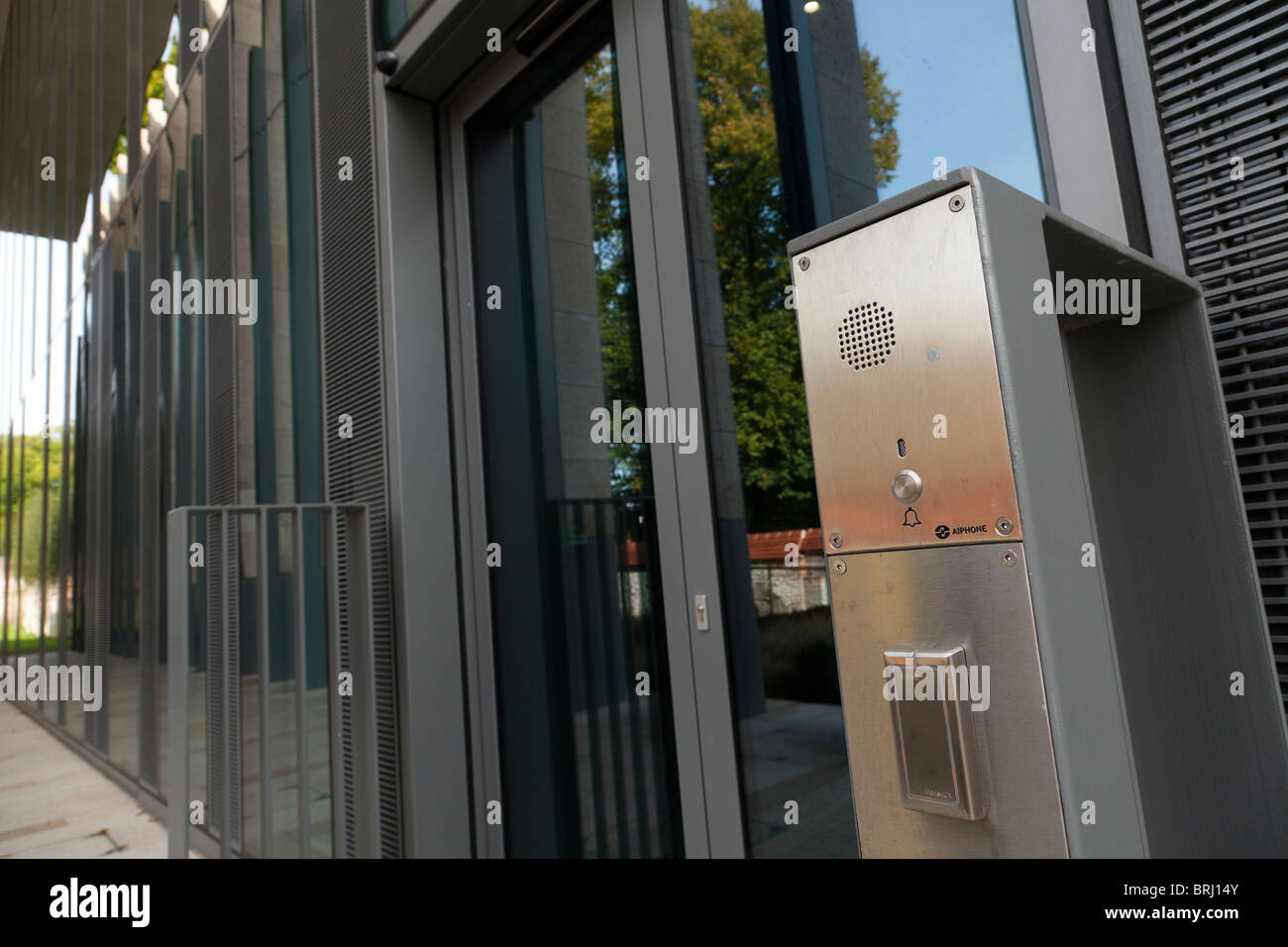 electronic door entry system with speaker and swipe card reader on commercial building Stock Photo