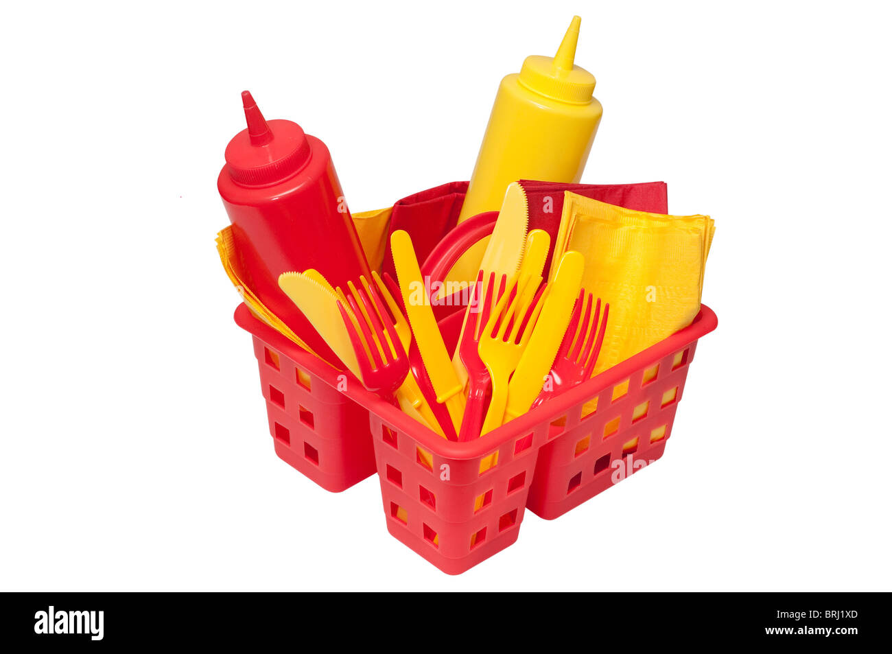 Ketchup, mustard, forks, knives, and napkins in basket. Stock Photo
