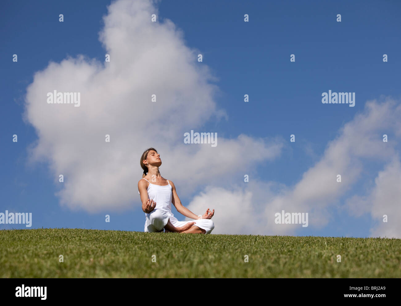 young woman enjoying nature in a yoga pose Stock Photo - Alamy