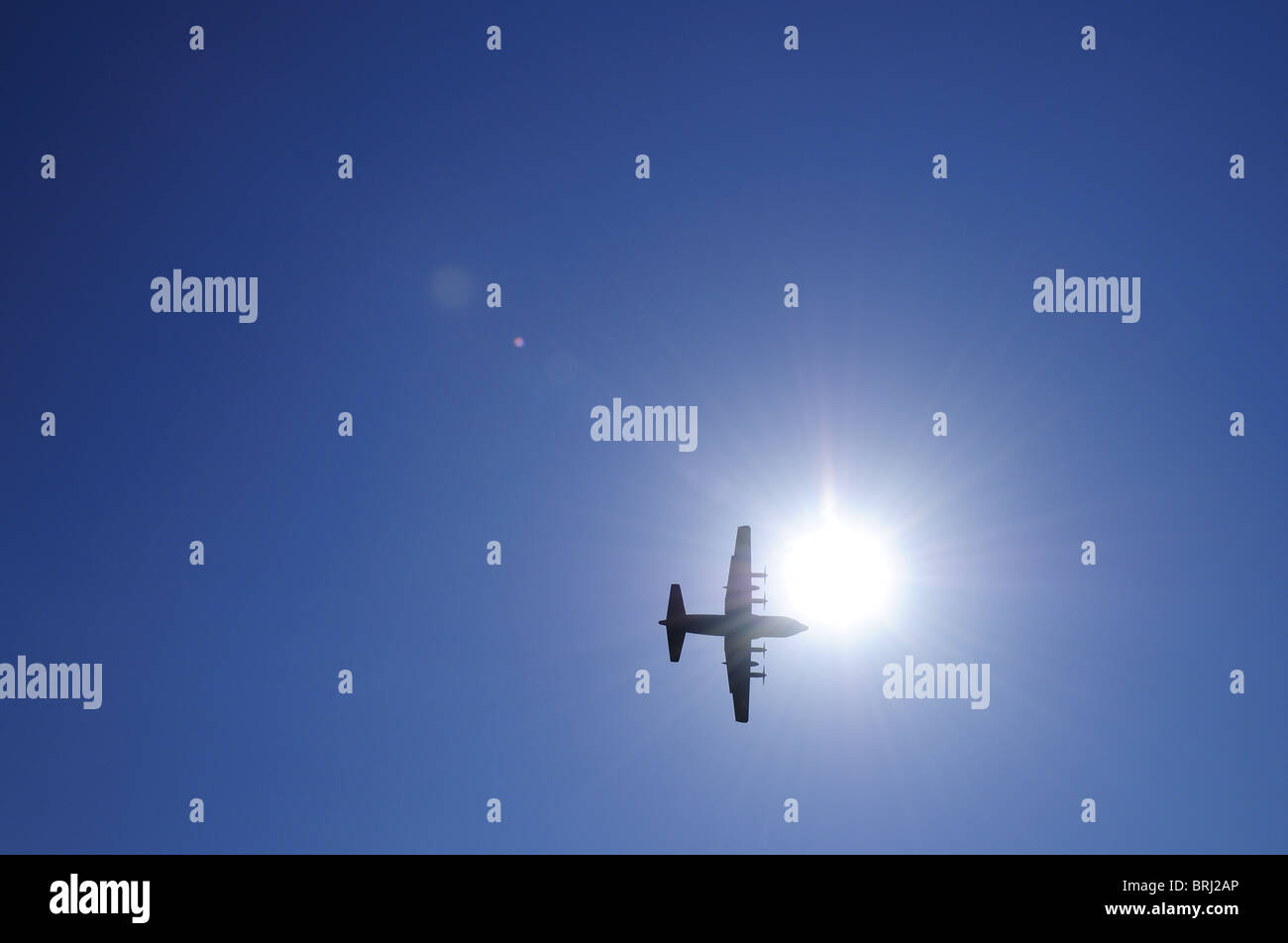 Military four engine aircraft in the sun Stock Photo