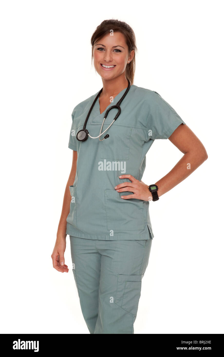 Three quarter view of pretty young nurse wearing green scrubs on white