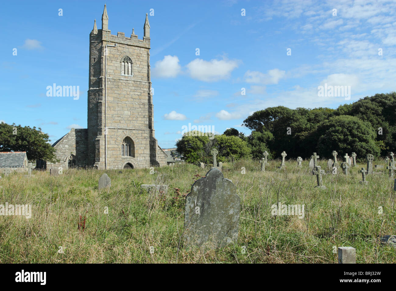 Overgrown grass in the old graveyard at St Uny's Church in Lelant, Cornwall UK Stock Photo