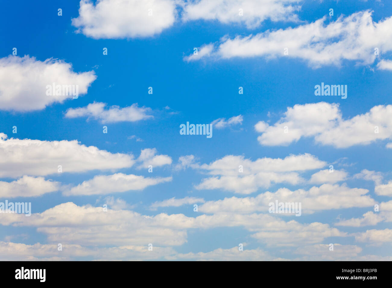 blue sky with white fluffy clouds background Stock Photo - Alamy