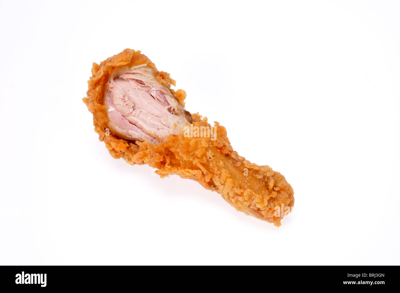 Cooked crispy fried chicken drumstick with bite taken on white background cut out. Stock Photo