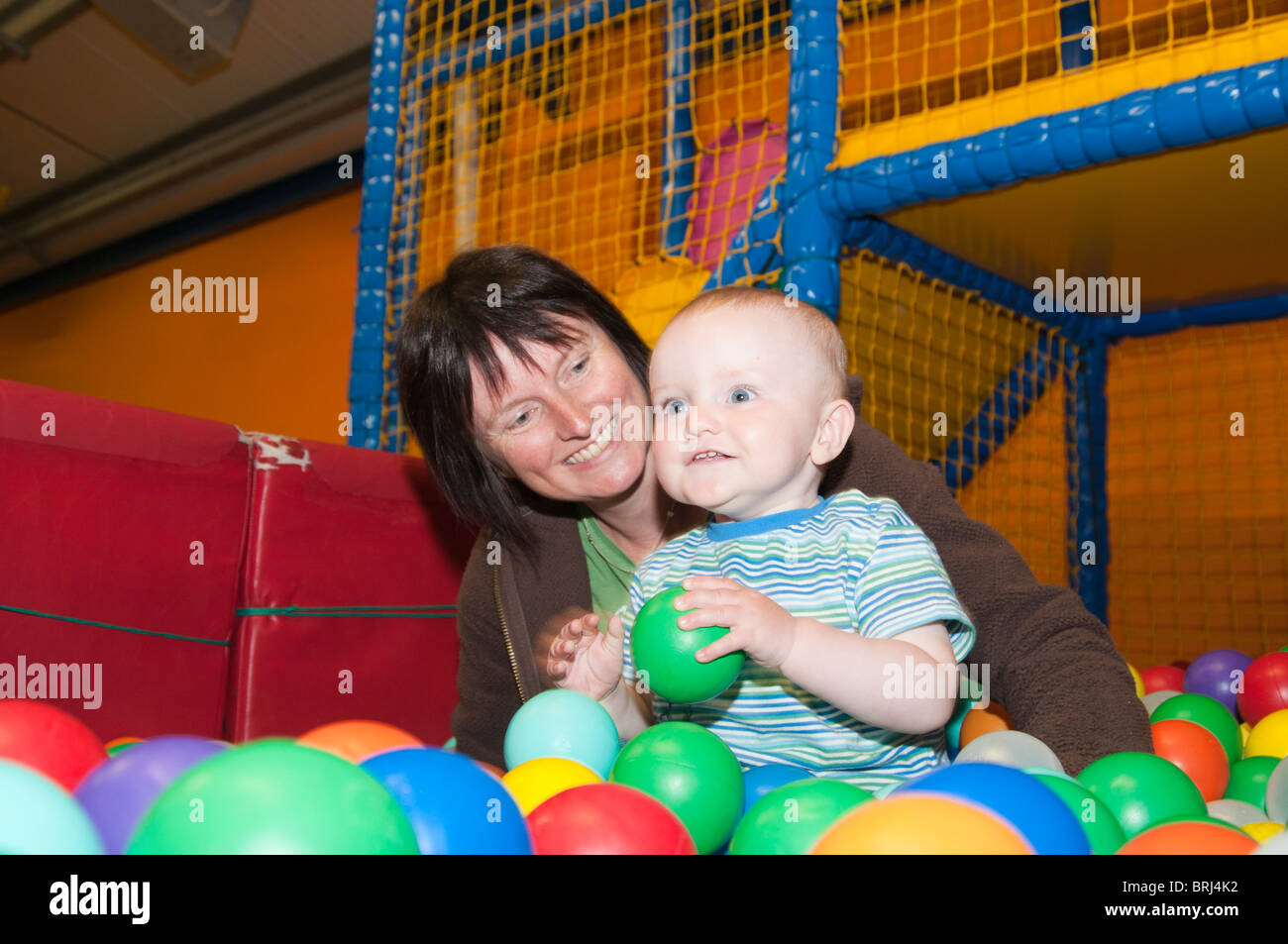 Mother and son in ball play pen Stock Photo