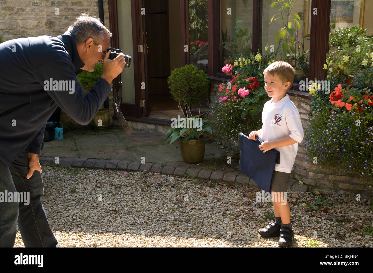 Dad taking photos of his son, first day of school Stock Photo