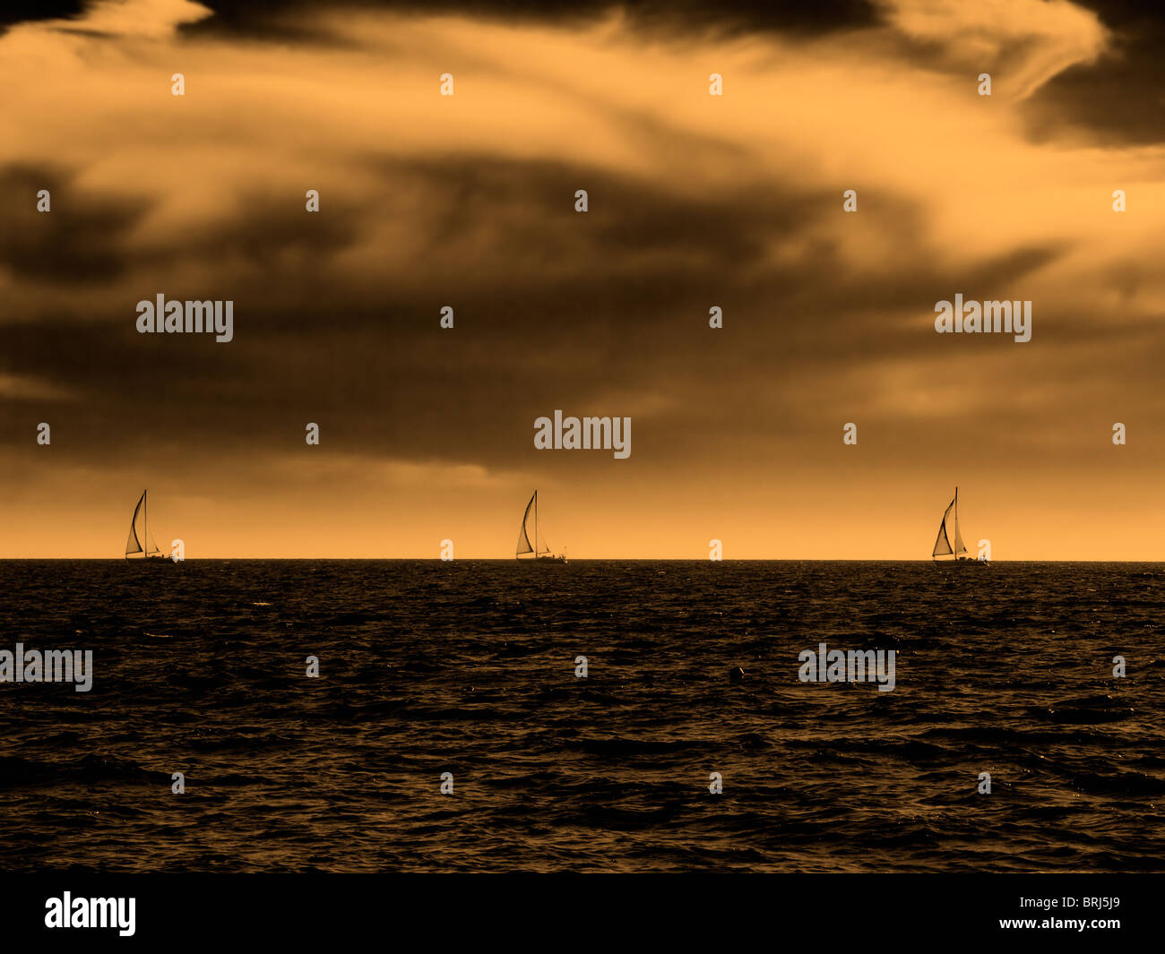 Desert colors in the stormy sky over the sea. Toned image. Stock Photo