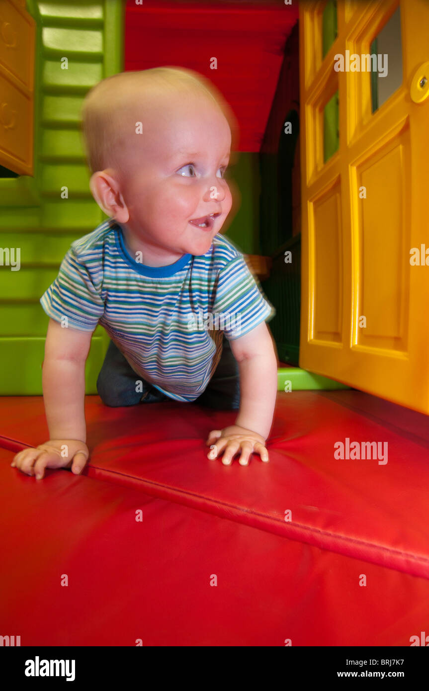 Baby crawling through play house door Stock Photo Alamy