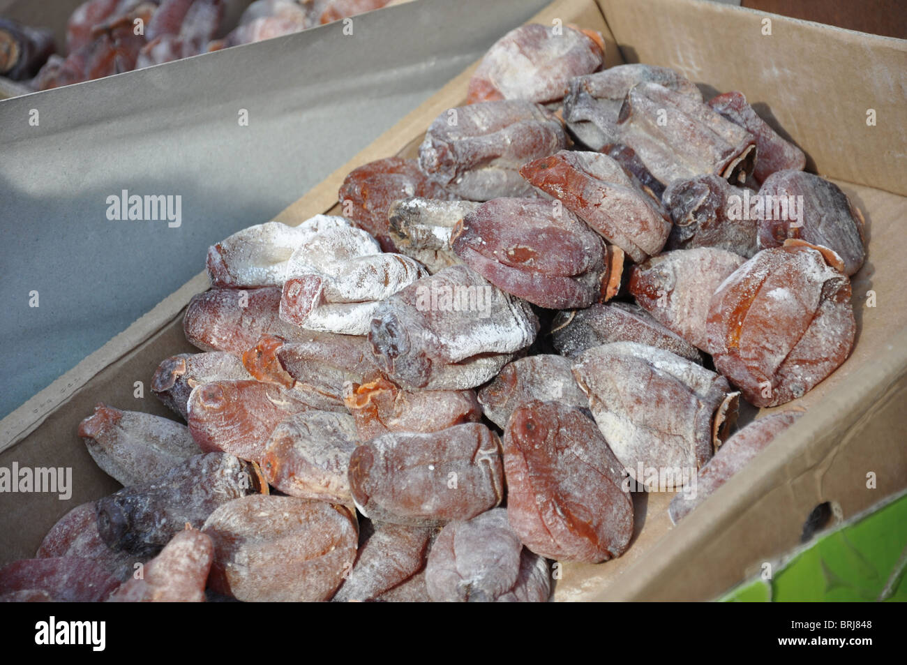 Dried Kaki Persimmon Fruit at street market in Beijing China Stock Photo