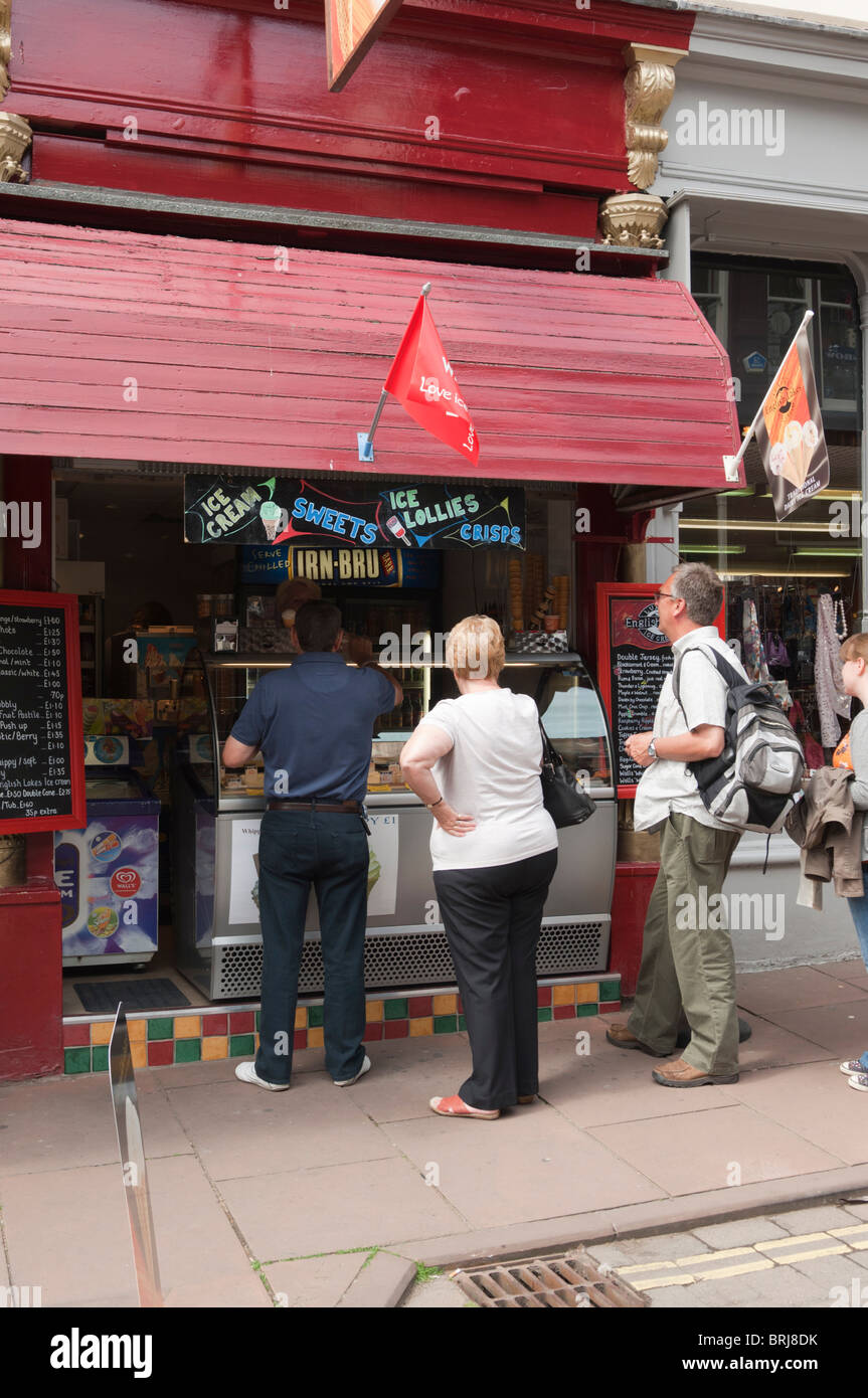 People buying ice creams in a shop store at Keswick , Cumbria , England