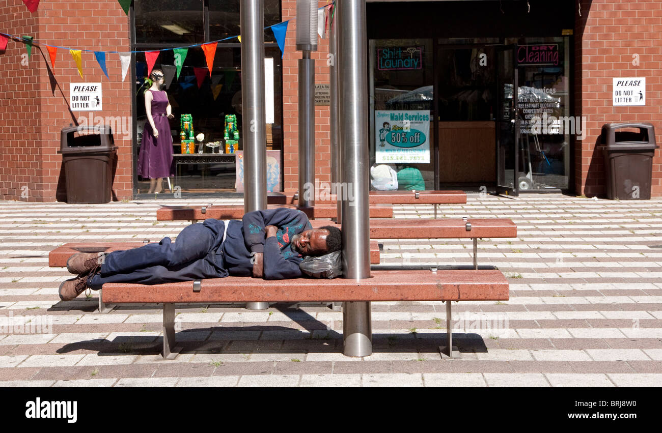 Homeless man sleeping on a bench, New York City, New York. Stock Photo