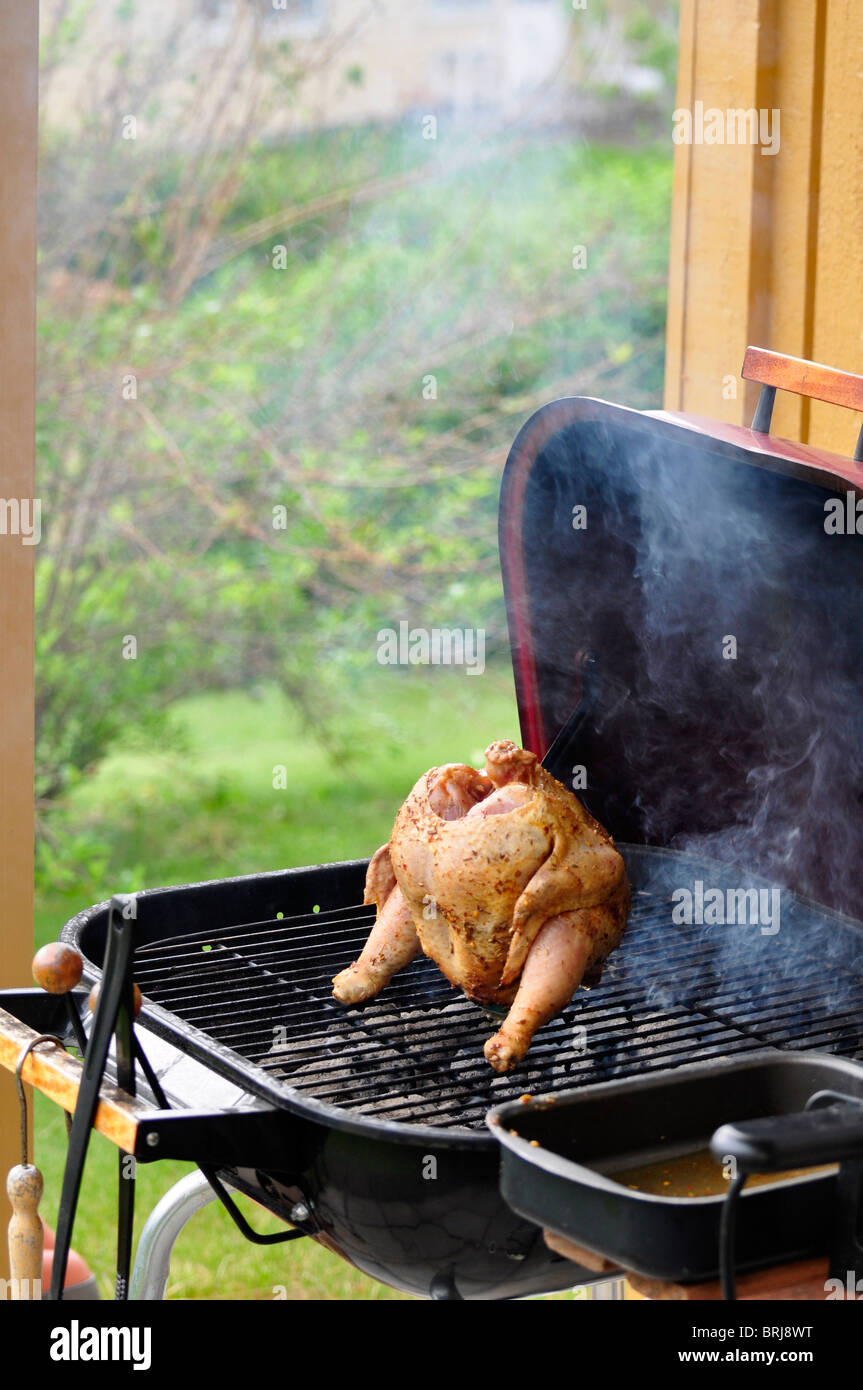 Marinated and Barbecued Chicken stuffed with a Beer Can in Sweden Stock Photo