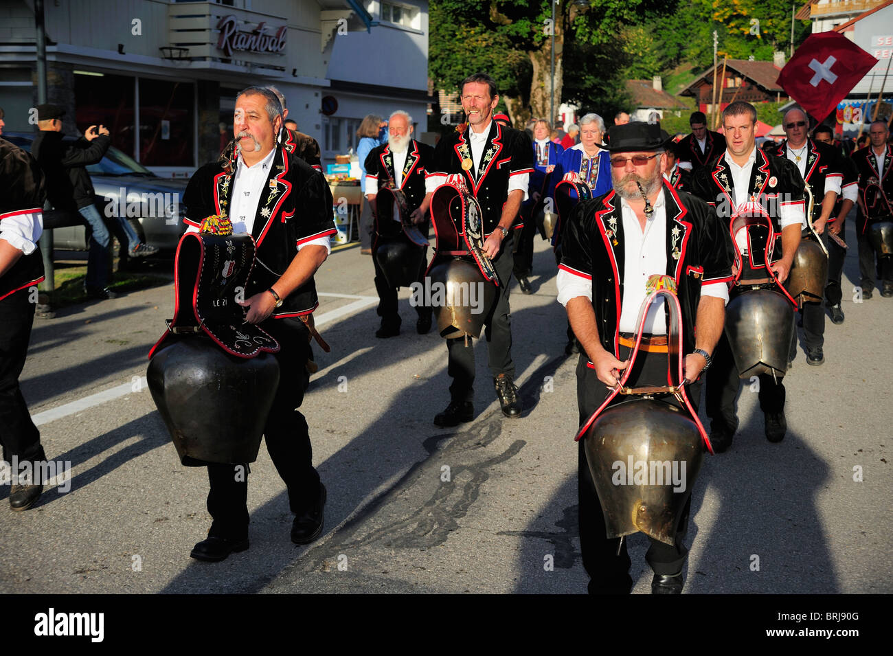 A Swiss tradition,  cowbell ringers walk through a village ringing their bells in unison Stock Photo