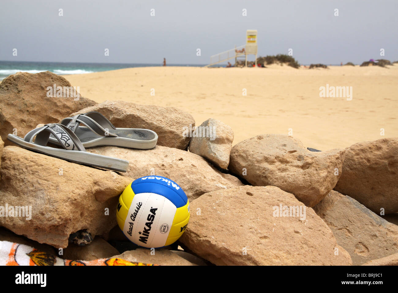 Flip flops and beach ball in beach shelter Stock Photo - Alamy