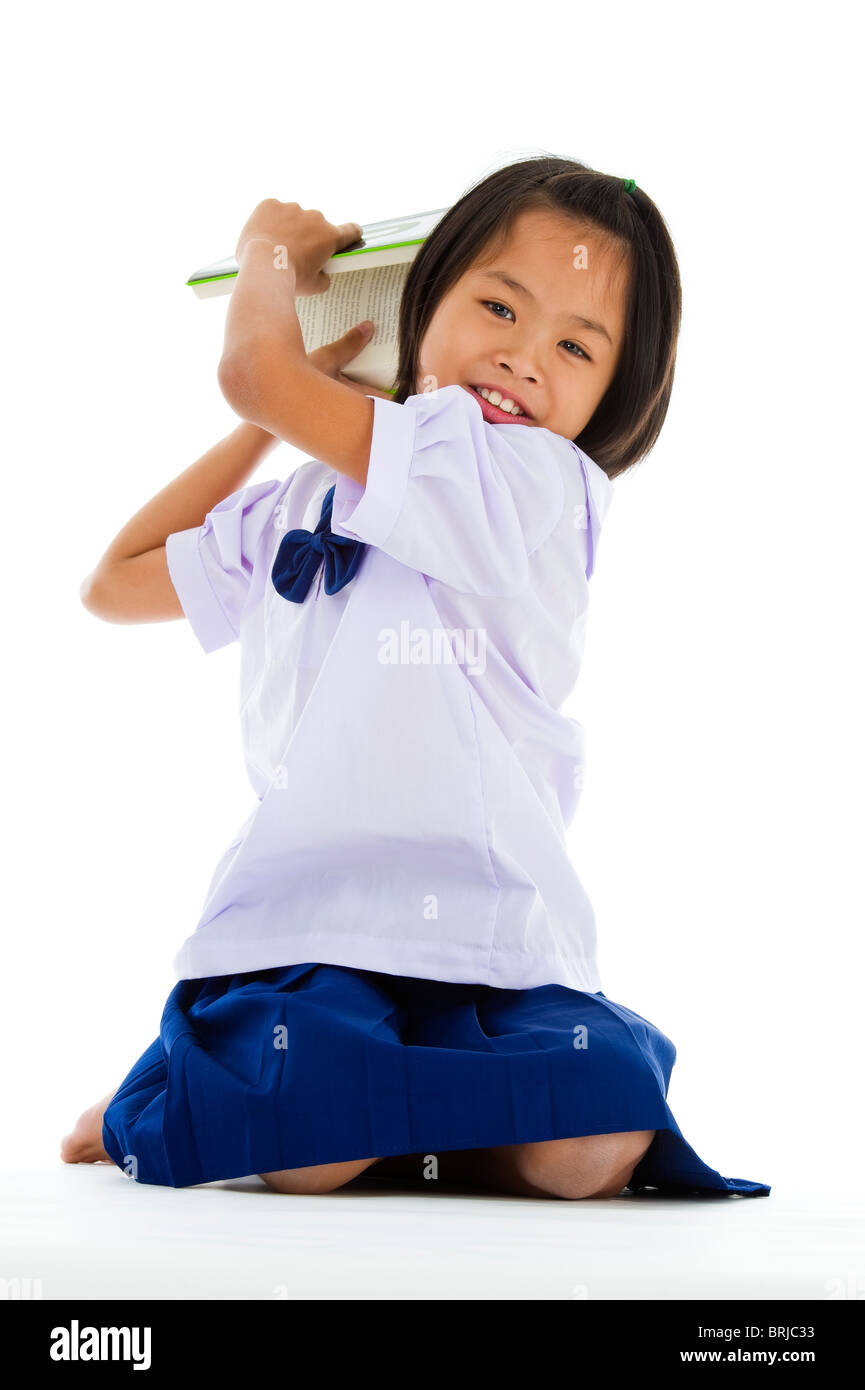 cute girl throwing a book, isolated on white background Stock Photo