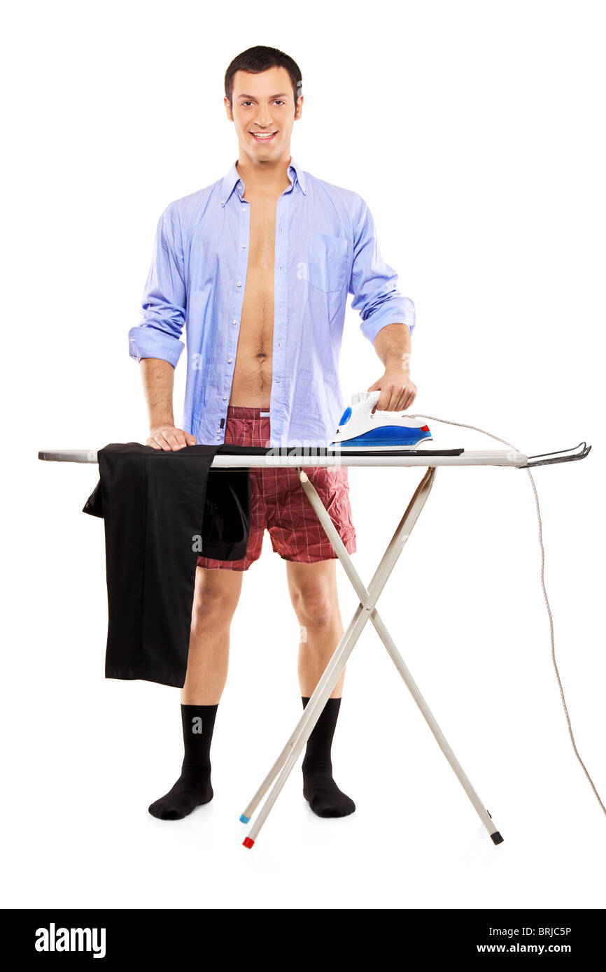 A full length portrait of a man ironing on a ironing board his pants