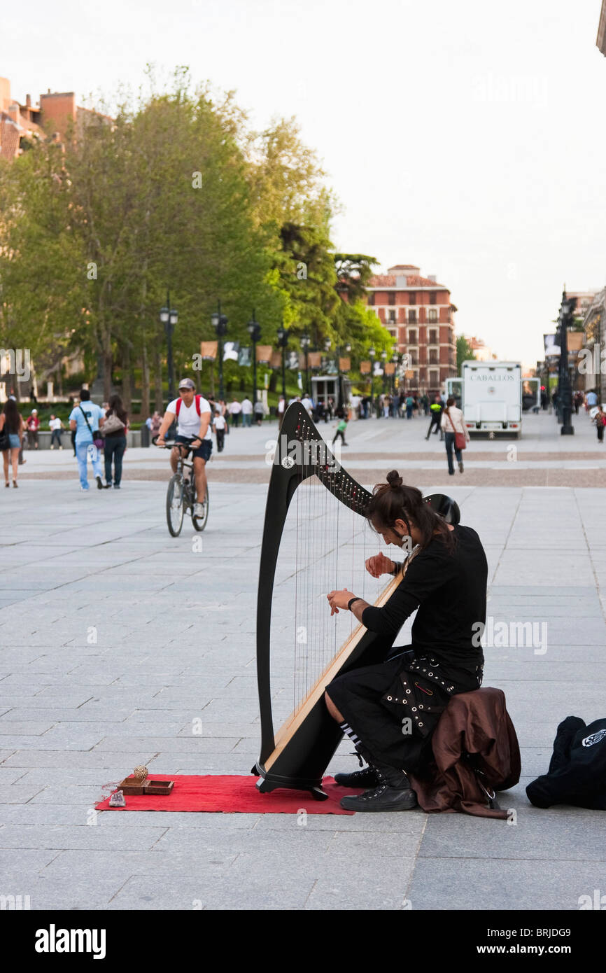 man playing harp in madrid street Stock Photo