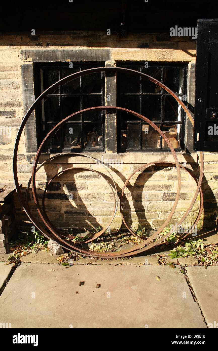 Shibden Hall Halifax Yorkshire symetrical arrangement of Cart wheel rims Stock Photo