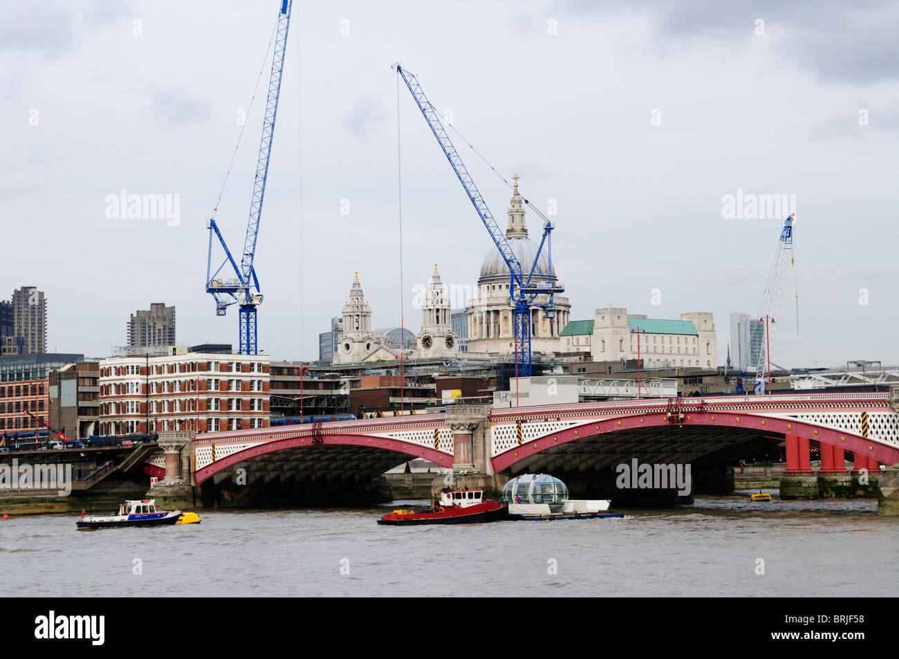 A London Eye Observation Capsule being transported down the Thames at Blackfriars Bridge, London, England, UK Stock Photo