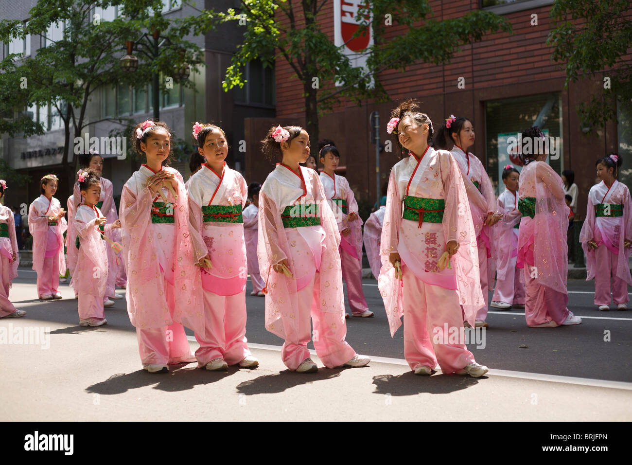 Four young girls dressed in soft pink Japanese outfits for Yosakoi street dance festival. Stock Photo