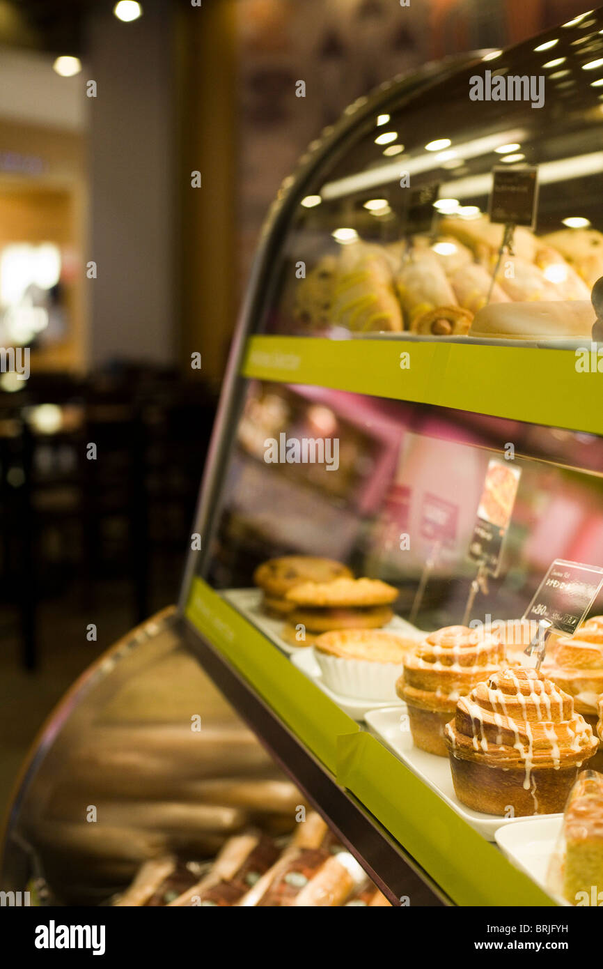 Food display unit in café, showing different pastries and sweets Stock