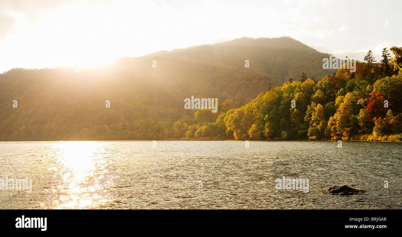 Lake Shikotsu in Autumn/Fall with sun directly in front. Stock Photo