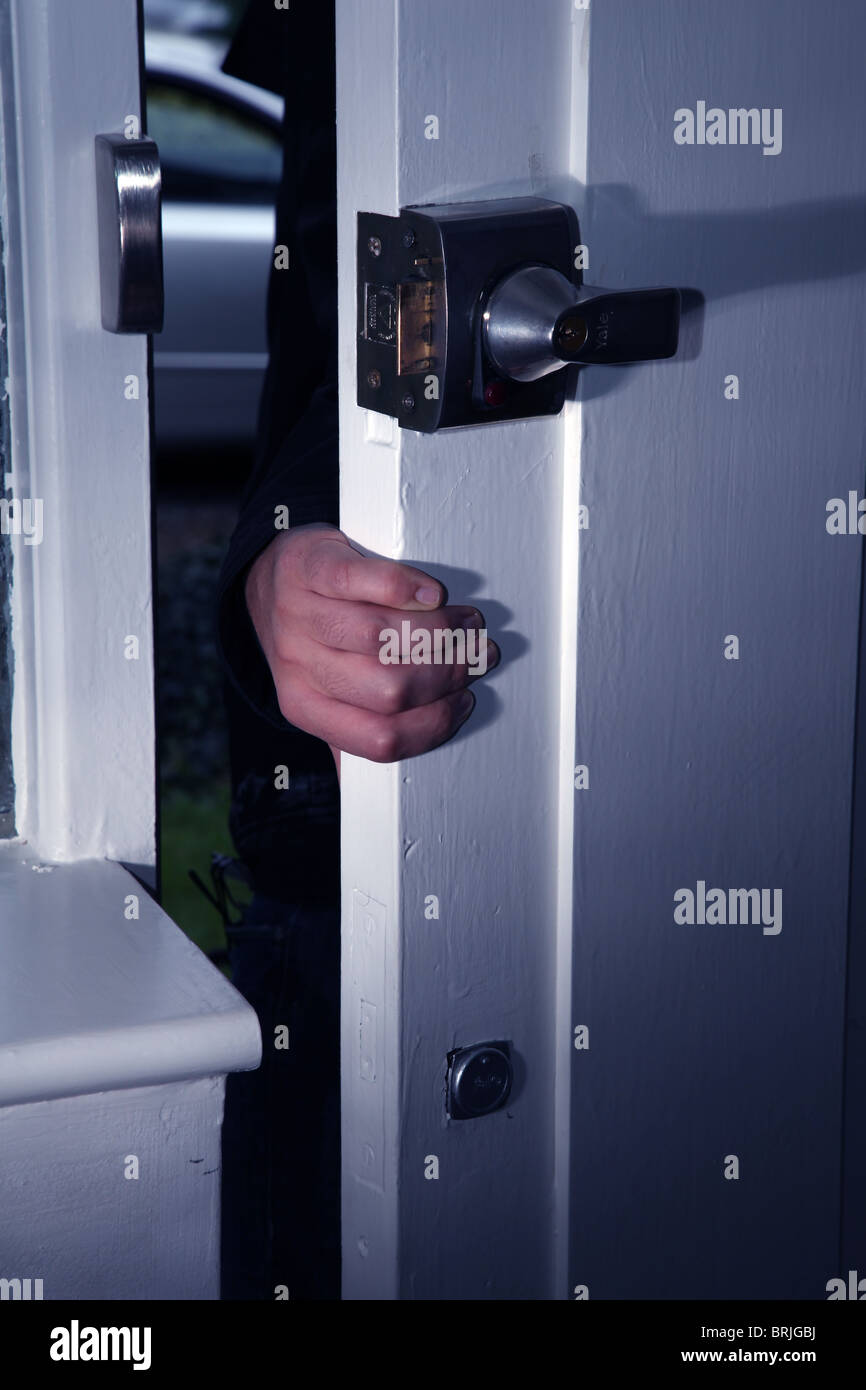 Hand encroaching into a door being opened at night Stock Photo - Alamy