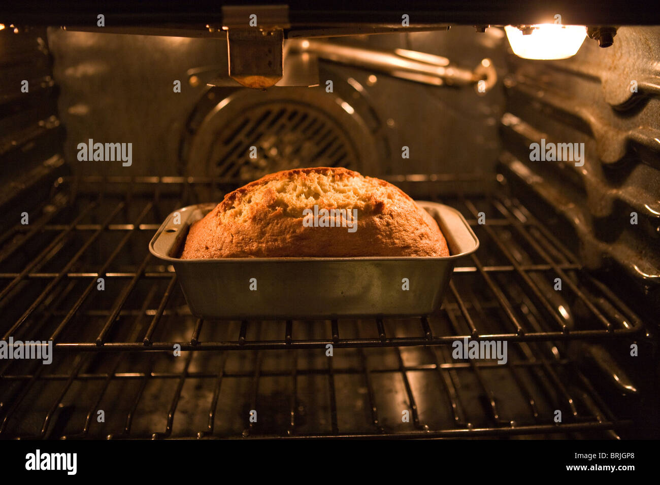 banana bread burning in an oven, over baking, turning dark brown Stock Photo