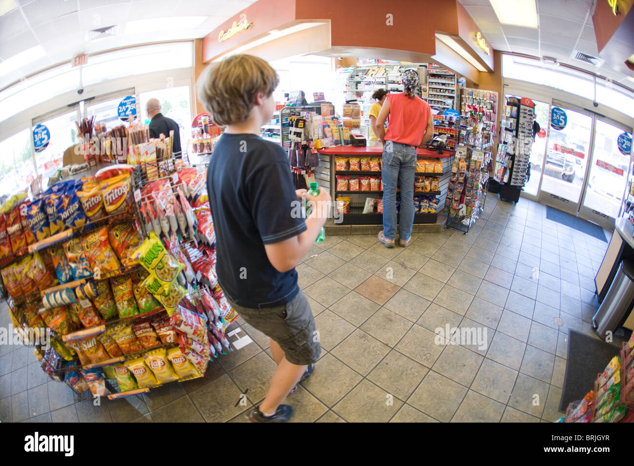 Boy walking through a convenience store Stock Photo