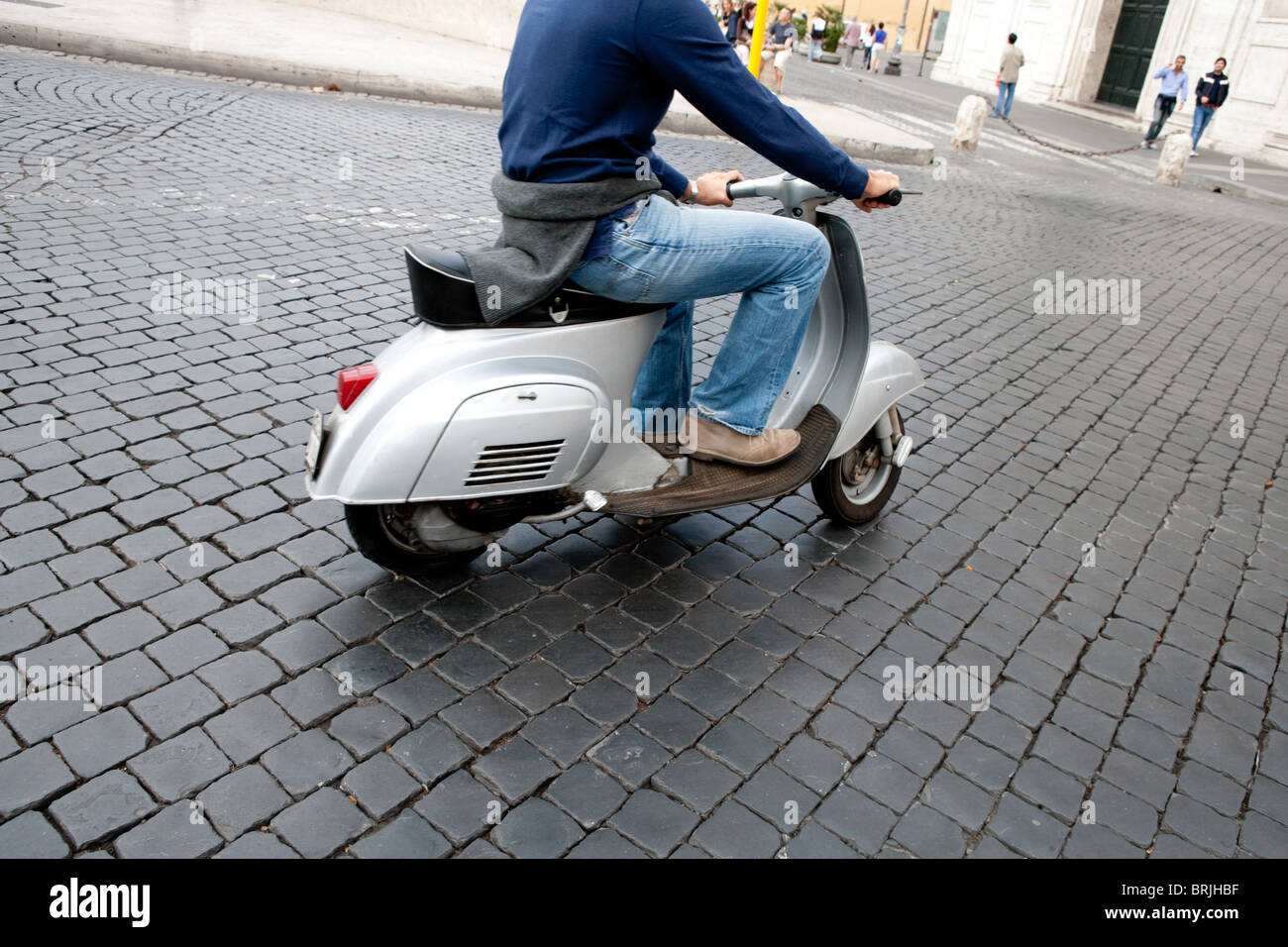 man riding driving Vespa Piaggio vintage motorcycle Rome Italy Europe Stock Photo