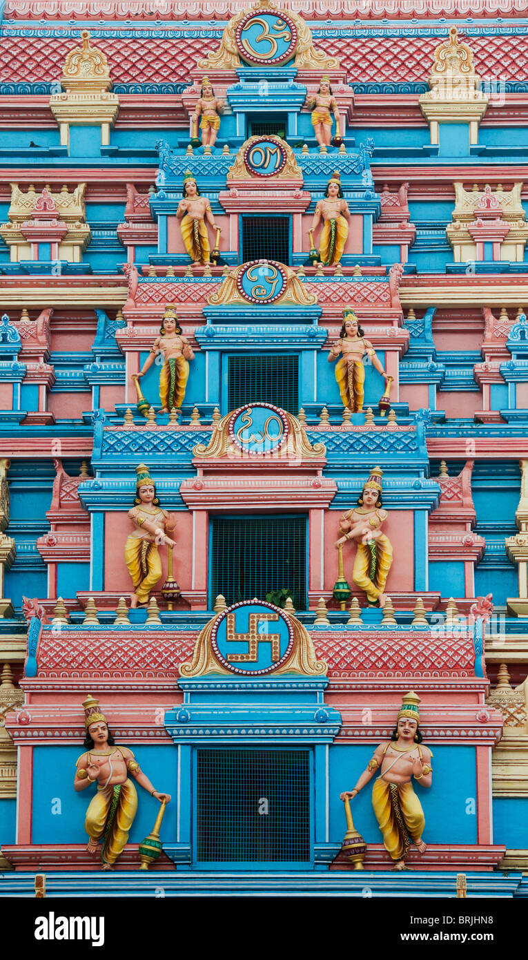 Indian gopuram temple architecture in the South Indian town of Puttaparthi showing hindu deities. The entrance to the ashram of Sathya Sai Baba Stock Photo