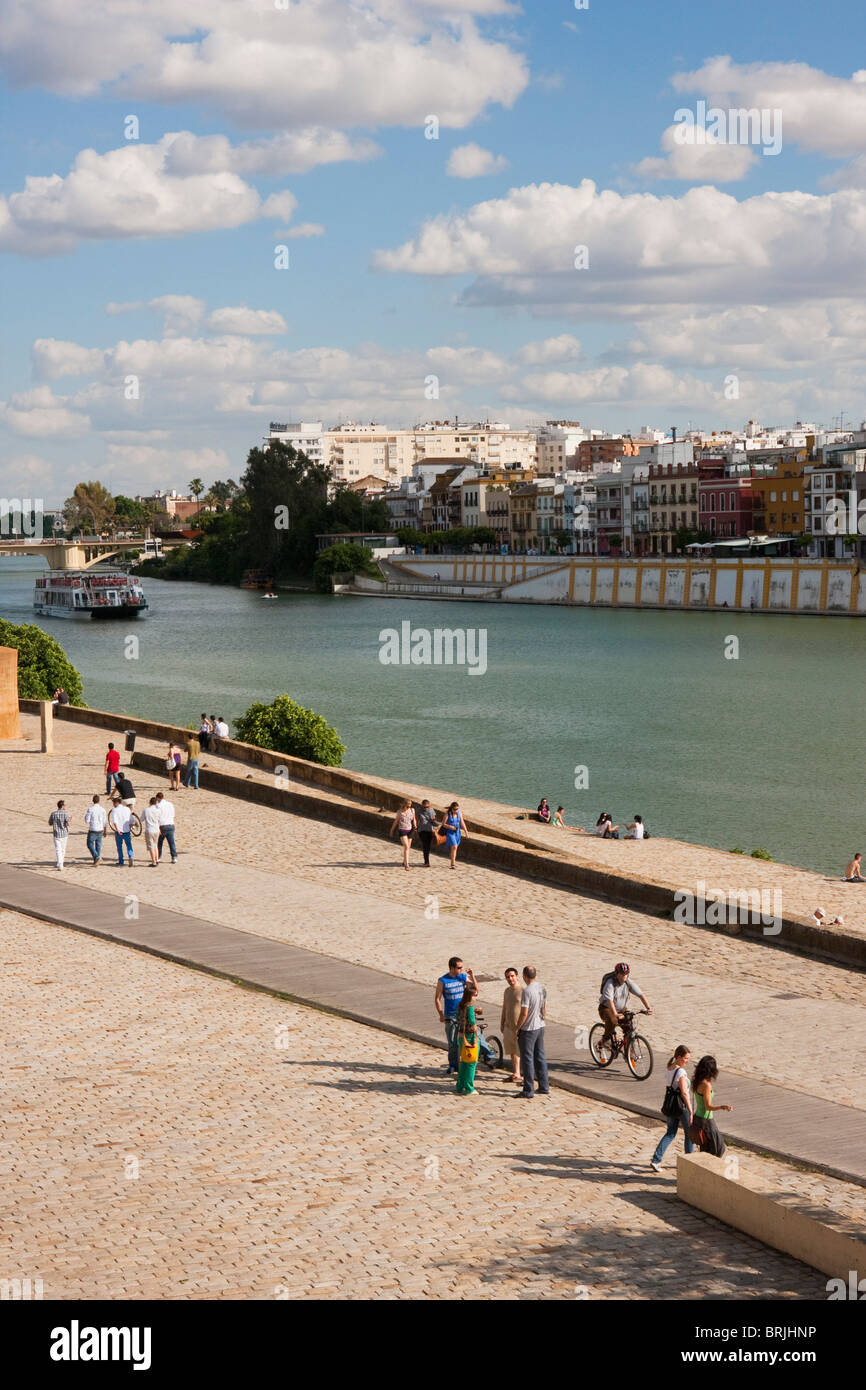 local people walking along the river in sevilla, spain Stock Photo