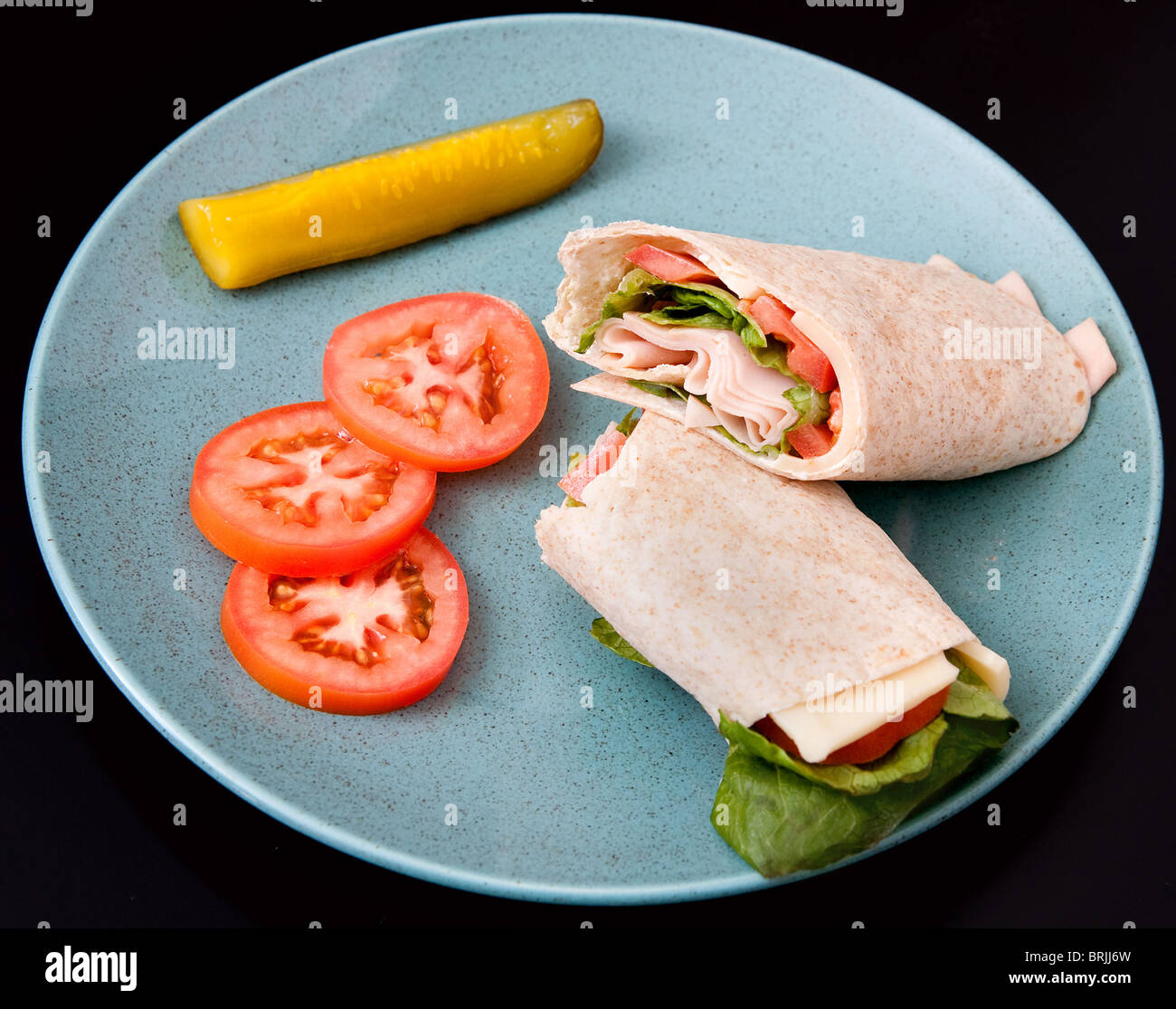 one cut turkey, tomato and lettuce wrap sandwich Stock Photo Alamy