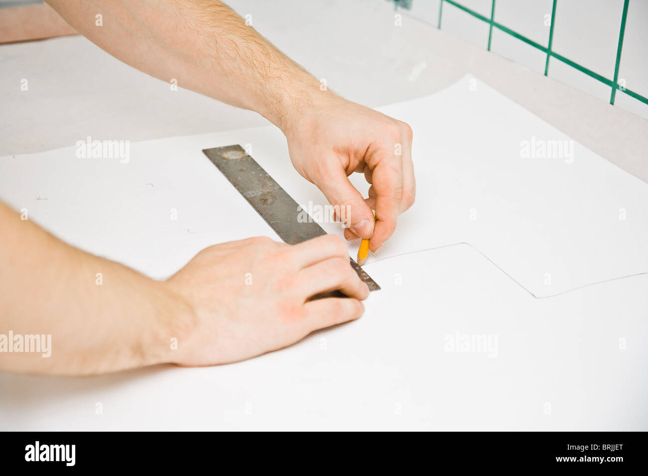 Hands with ruler and pen drawing line Stock Photo - Alamy