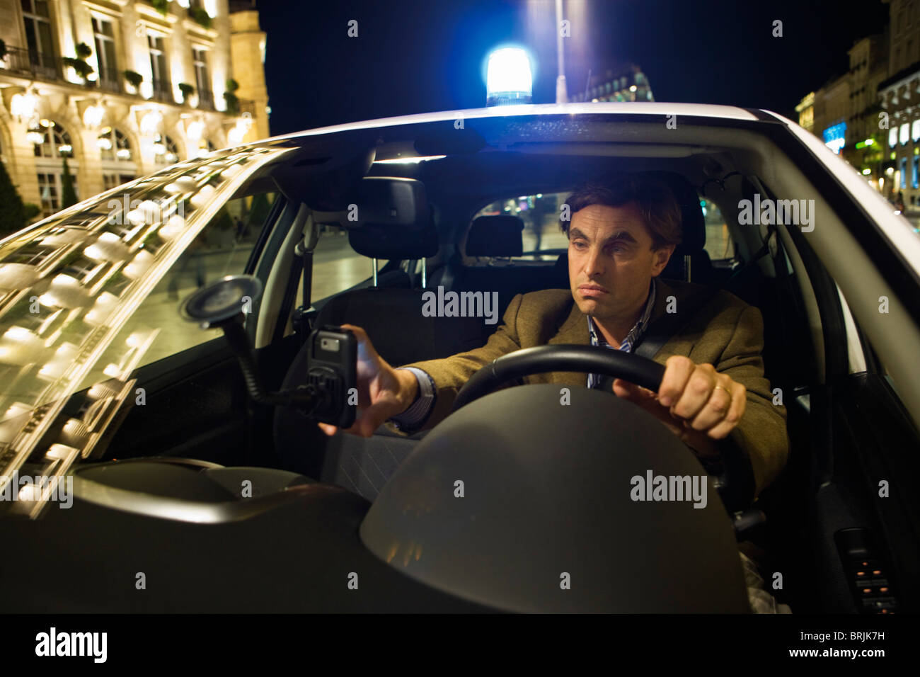 Emergency oncall doctor using GPS to navigate his way to a house call at night Stock Photo Alamy