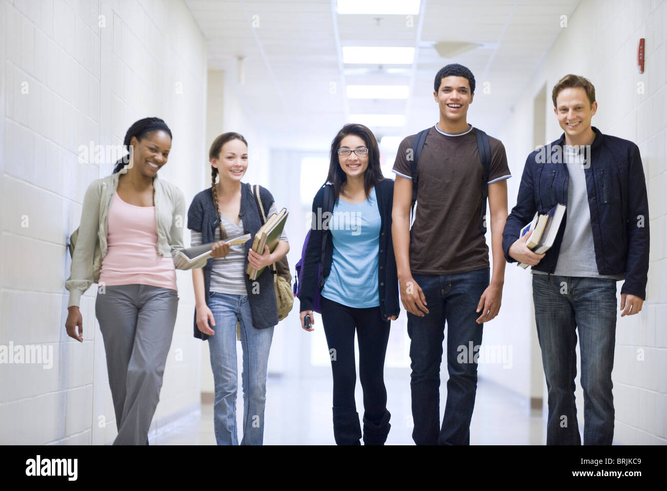 High school students walking down school corridor Stock Photo - Alamy
