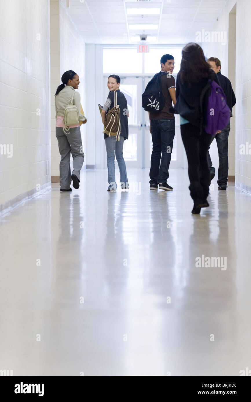 High school students walking down school corridor Stock Photo