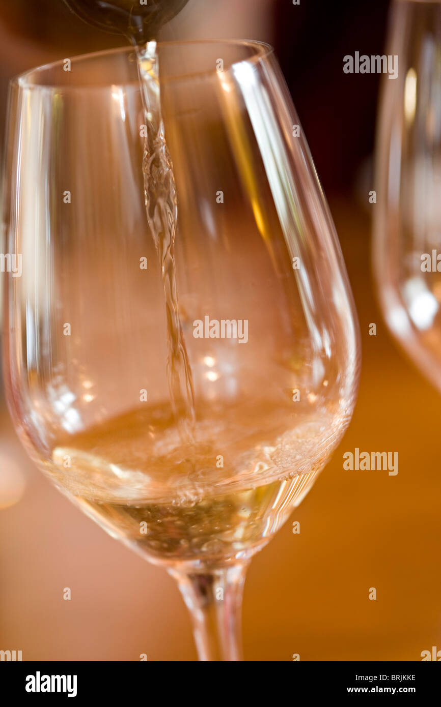 Pouring glass of white wine Stock Photo