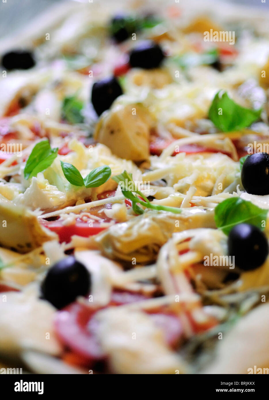 Uncooked toppings on fresh pizza, close-up Stock Photo