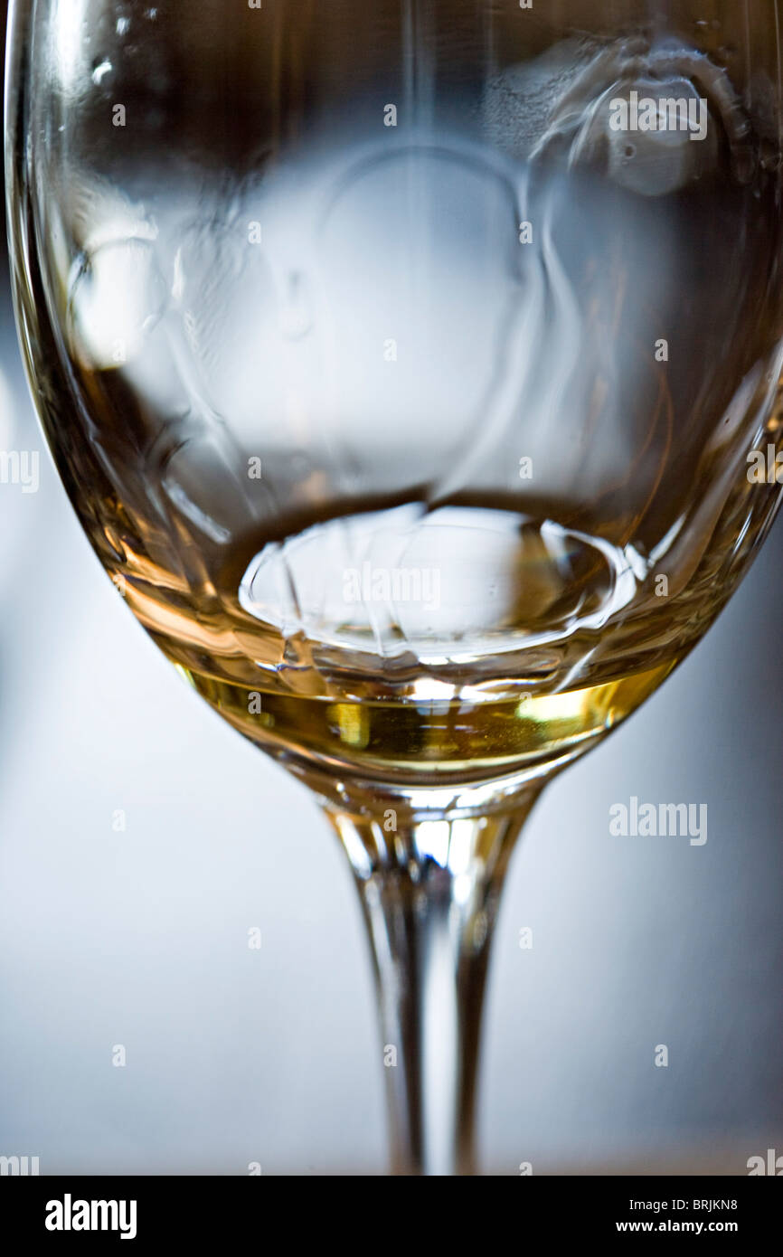 Tears of wine on glass of white wine Stock Photo