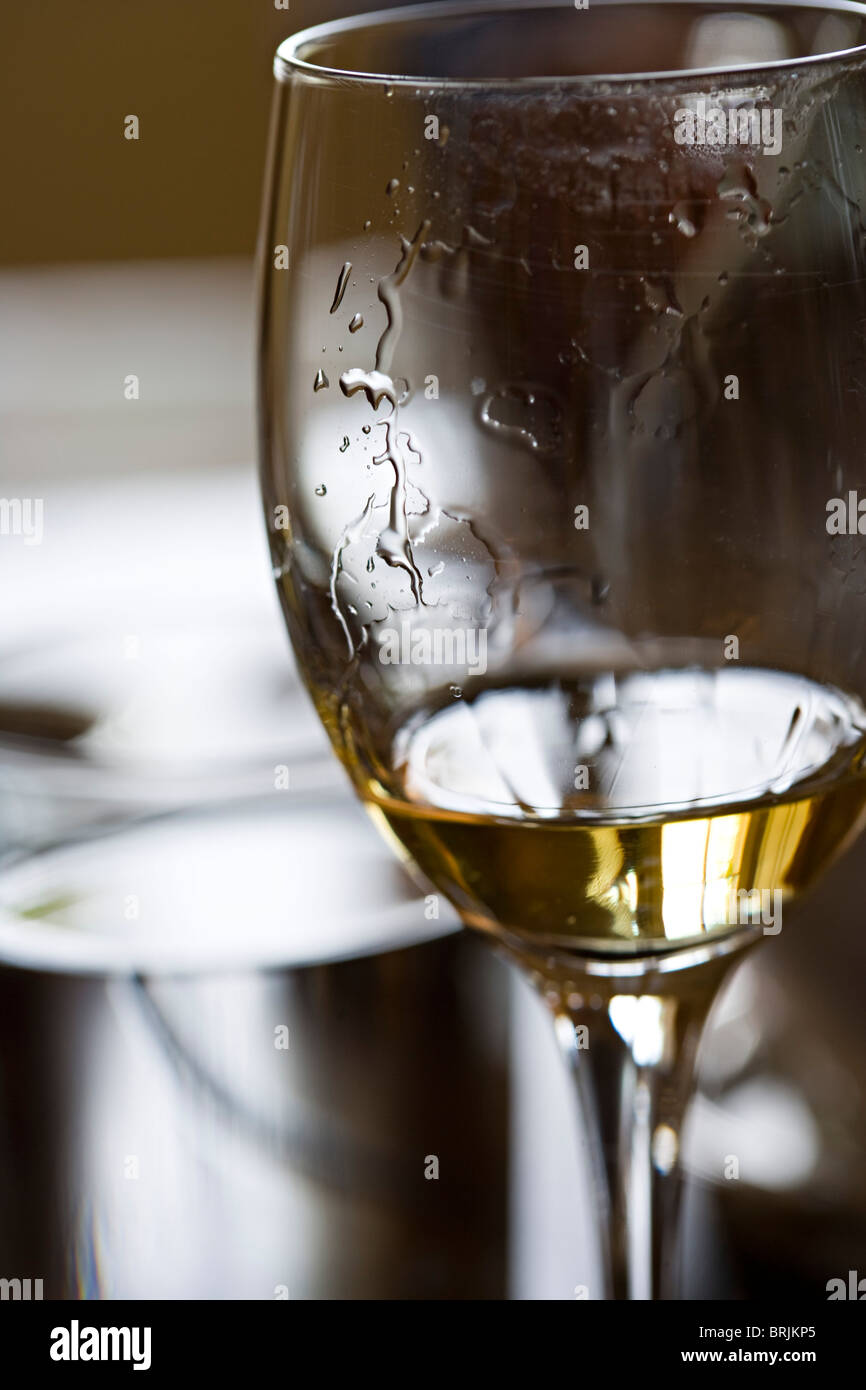 Tears of wine on glass of white wine Stock Photo
