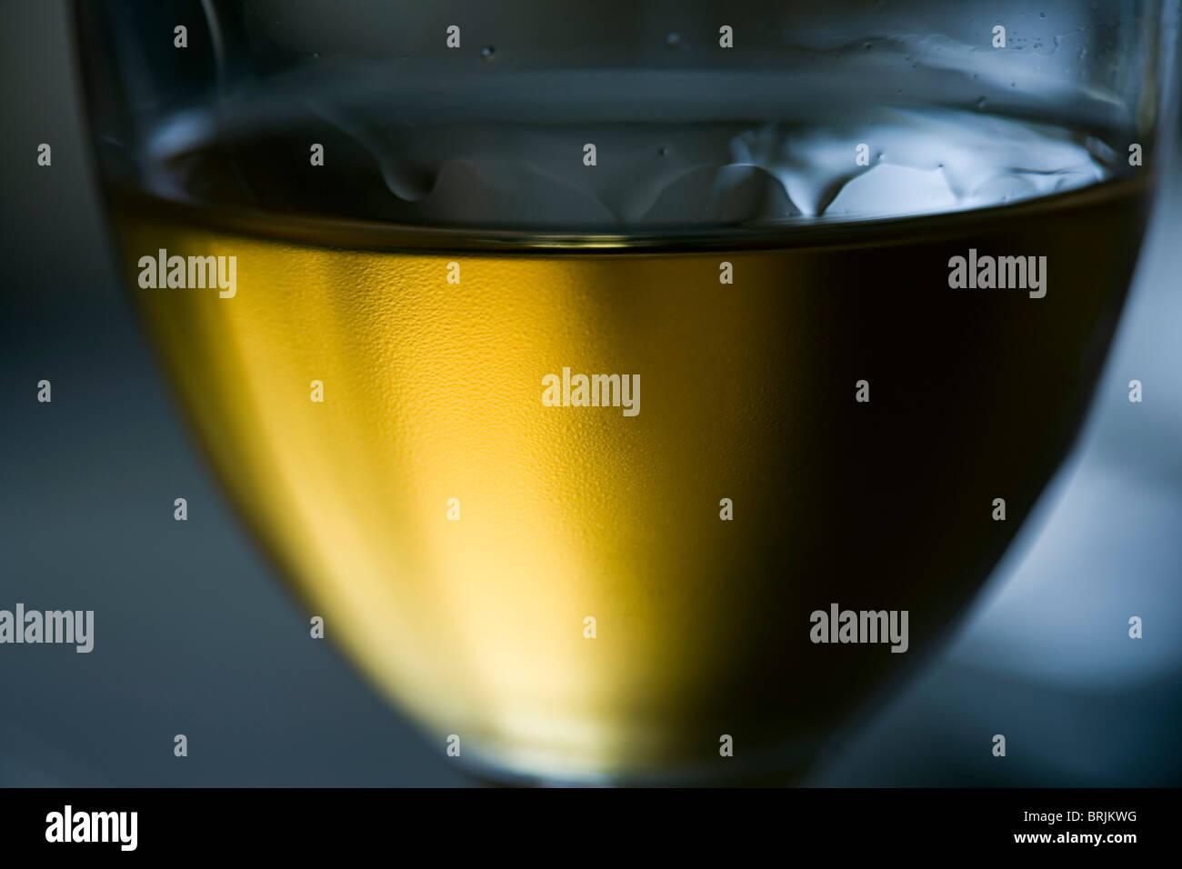 Tears of wine on chilled glass of white wine Stock Photo