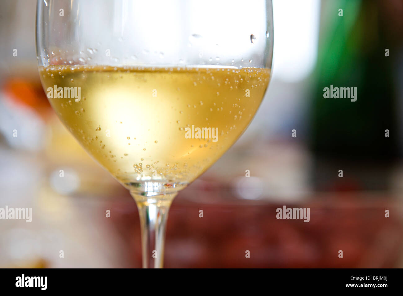 Droplets of condensation on glass of chilled white wine Stock Photo