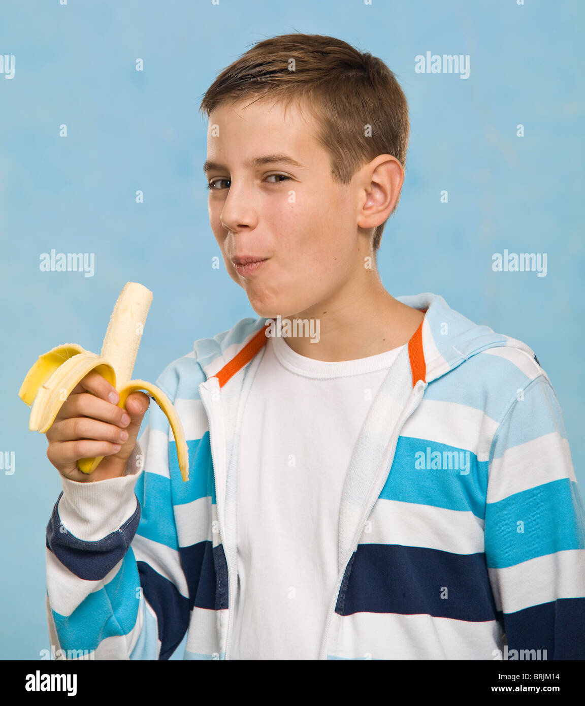 Boy Eating Banana Stock Photo