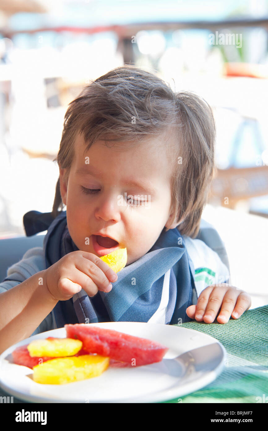 Baby Boy Eating Fruit Stock Photo Alamy