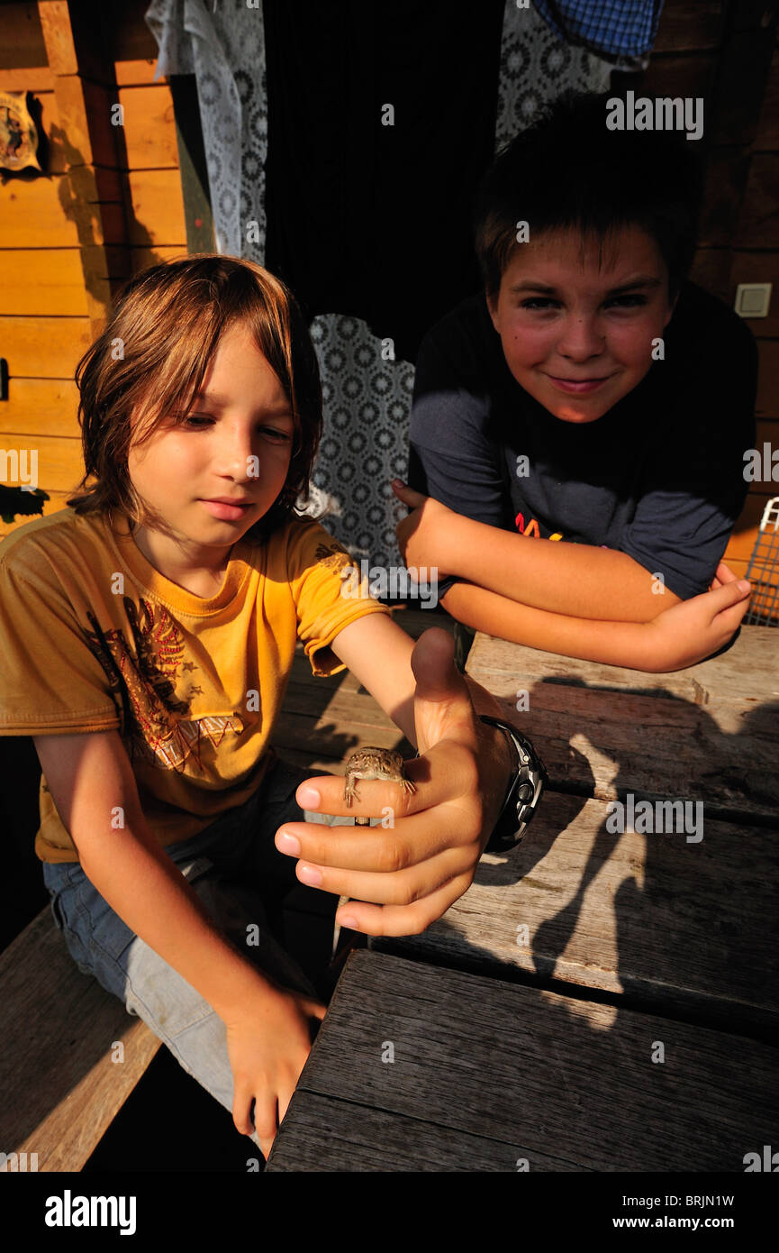 Two boys with captured lizard Stock Photo